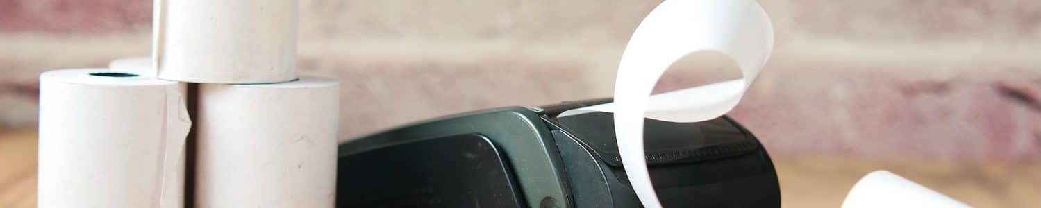 POS machine and long roll paper on table