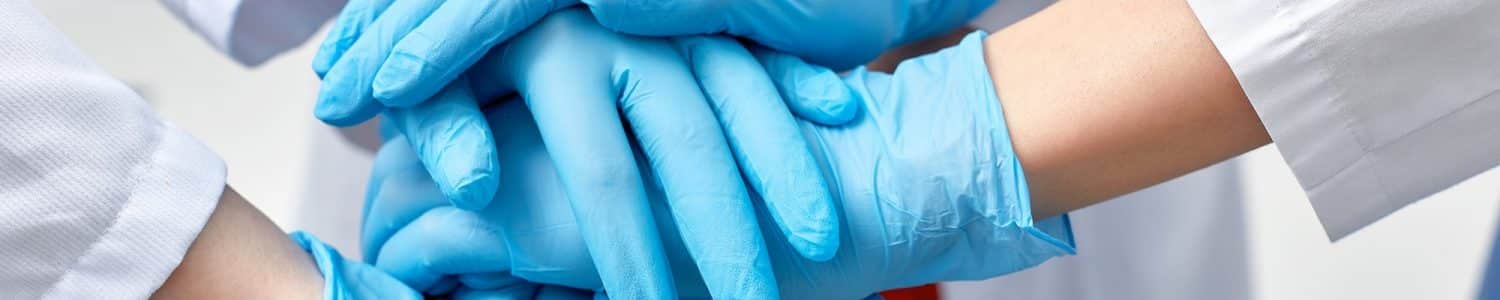 Hands in blue gloves covid, concept - creative team with hands on top of each other. Diverse team putting their hands together. One for all gesture in gloves. Covid-19 concept